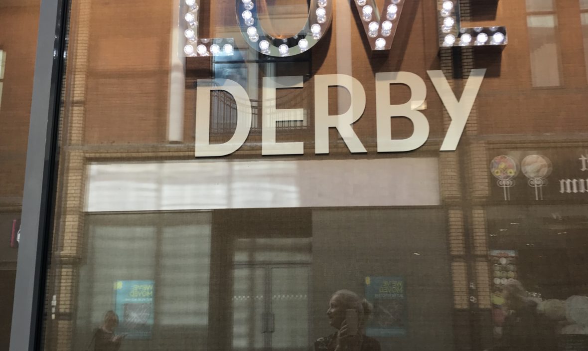 photo of the sign on a building that says 'love derby'