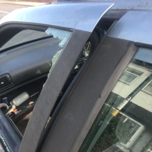 photo of car window broken in breakin